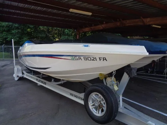 Slide: The Image of 2001 Warlock 29 World Class boat on trailer under shelter. - 18