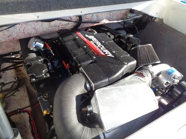 Slide: The Image of Engine compartment of a 2001 Warlock 29 World Class boat with Mercury engine. - 21
