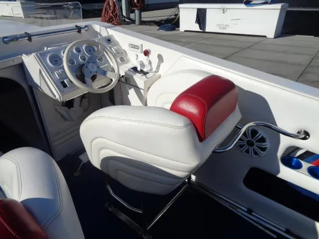 Slide: The Image of 2001 Warlock 29 World Class boat interior with white and red seating, steering wheel, and dashboard. - 5