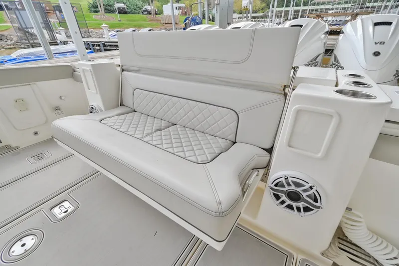 Slide: The Image of 2021 Pursuit S 428 Sport boat with cushioned seating and speaker system. - 10