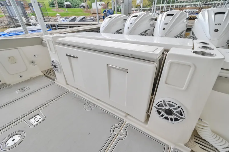 Slide: The Image of 2021 Pursuit S 428 Sport boat deck with storage and speakers. - 11