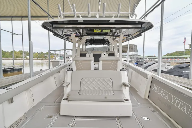 Slide: The Image of 2021 Pursuit S 428 Sport boat interior with seating and helm, docked at marina. - 12