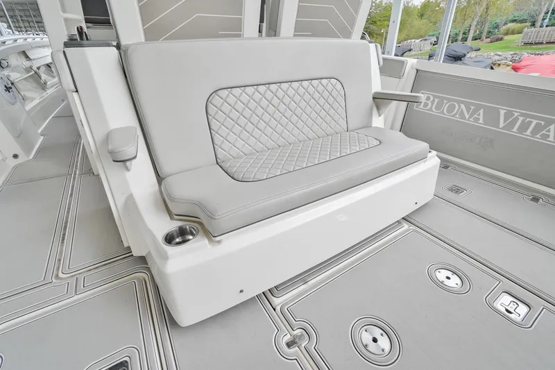 Slide: The Image of 2021 Pursuit S 428 Sport boat interior with cushioned seating and cup holder. - 13