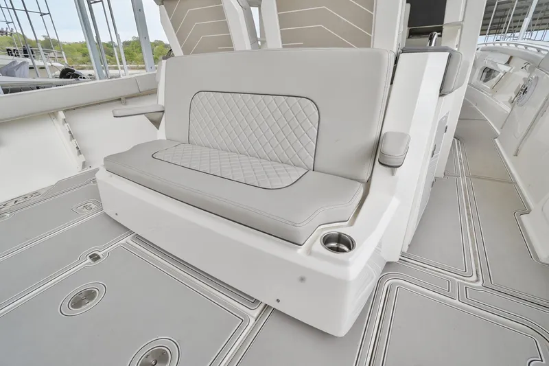 Slide: The Image of 2021 Pursuit S 428 Sport boat interior with cushioned seating and cup holder. - 15