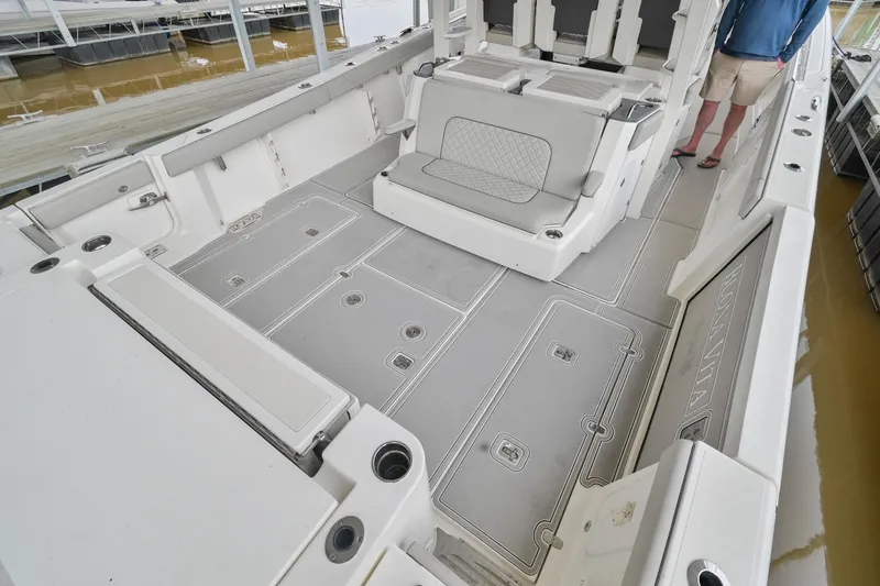 Slide: The Image of 2021 Pursuit S 428 Sport boat interior with spacious seating and storage compartments. - 16