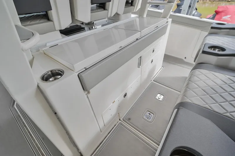 Slide: The Image of Interior of 2021 Pursuit S 428 Sport boat, featuring seating and storage compartments. - 24