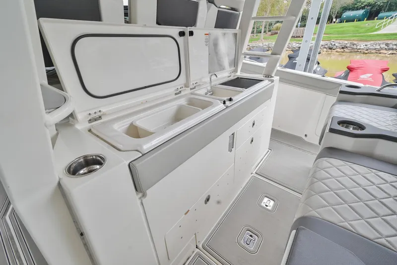 Slide: The Image of 2021 Pursuit S 428 Sport boat interior with sink and seating area. - 25