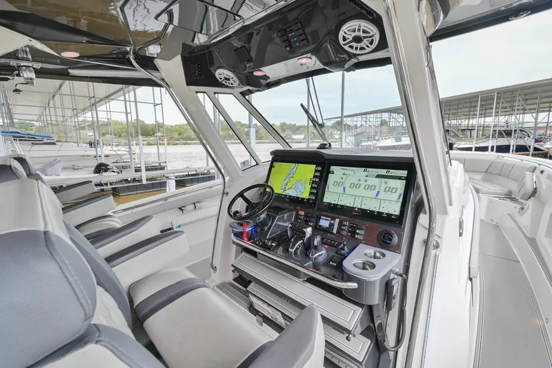 Slide: The Image of 2021 Pursuit S 428 Sport boat cockpit with advanced navigation system and luxurious seating. - 29