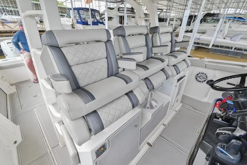 Slide: The Image of Luxury seating on 2021 Pursuit S 428 Sport boat, featuring plush, quilted upholstery. - 30