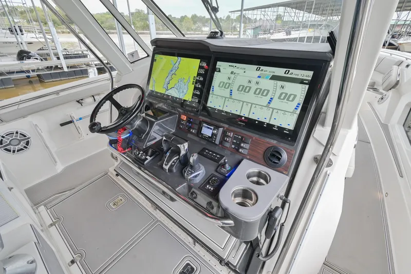 Slide: The Image of 2021 Pursuit S 428 Sport boat cockpit with advanced navigation displays and controls. - 31
