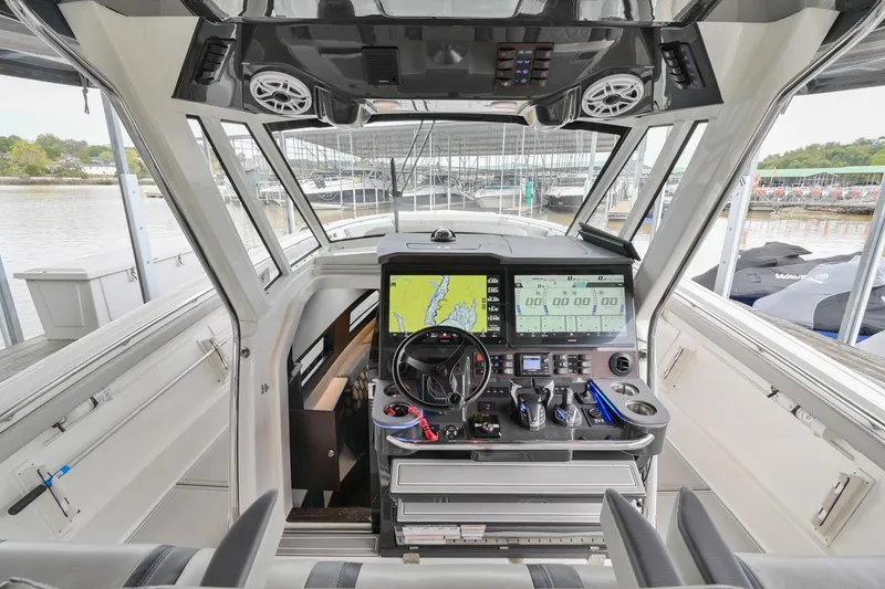 Slide: The Image of 2021 Pursuit S 428 Sport boat cockpit with advanced navigation system and controls. - 32