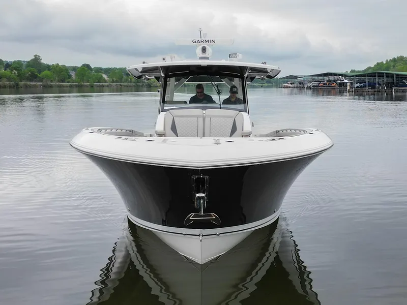 Slide: The Image of 2021 Pursuit S 428 Sport boat on calm water, front view, overcast sky. - 4