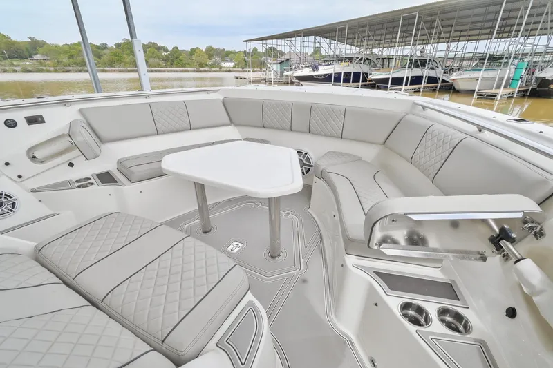 Slide: The Image of 2021 Pursuit S 428 Sport boat interior with luxurious seating and table setup. - 43