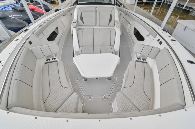 Slide: The Image of 2021 Pursuit S 428 Sport boat interior with luxurious seating and table setup. - 46