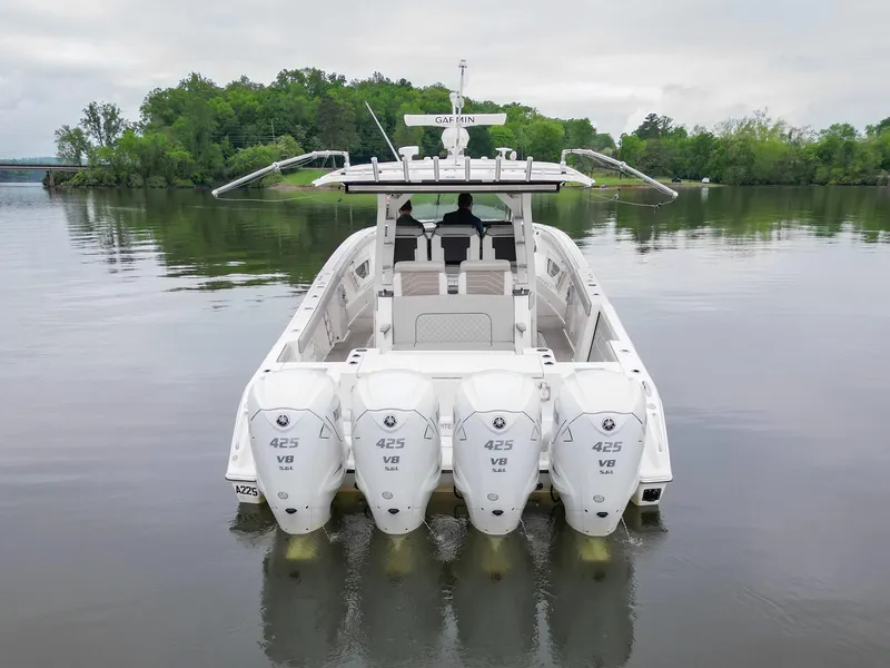 Slide: The Image of 2021 Pursuit S 428 Sport boat with four powerful engines on a calm lake. - 6