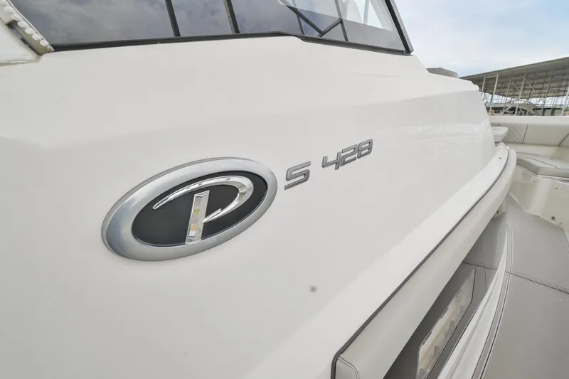 Slide: The Image of 2021 Pursuit S 428 Sport boat exterior with logo detail. - 7