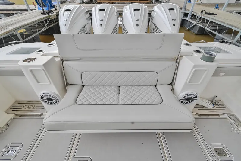 Slide: The Image of 2021 Pursuit S 428 Sport boat with cushioned seating and four outboard engines. - 9