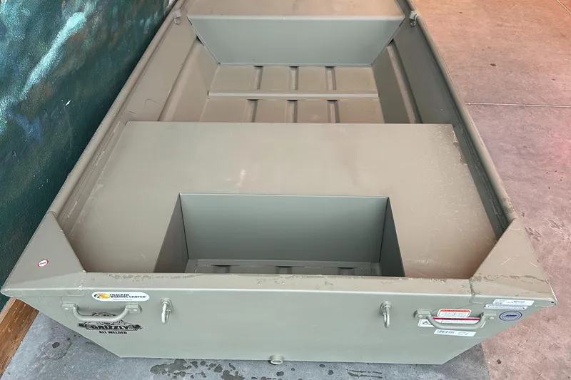 Slide: The Image of 2025 Tracker Grizzly 1436 Utility boat, olive green, sturdy design, ideal for fishing. - 2