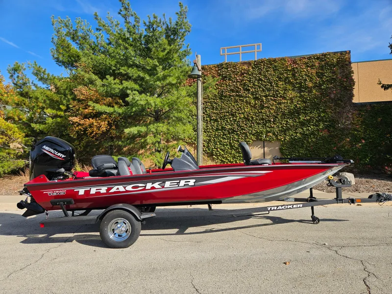 The Image of 2025 Tracker Pro Team 190 boat, red, parked outdoors on a trailer. - 0