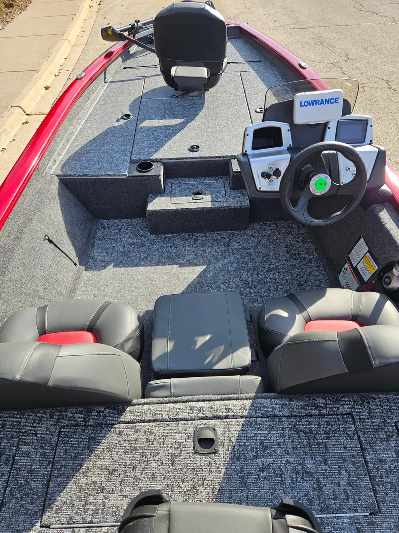 Slide: The Image of 2025 Tracker Pro Team 190 boat interior with steering wheel and Lowrance electronics. - 2