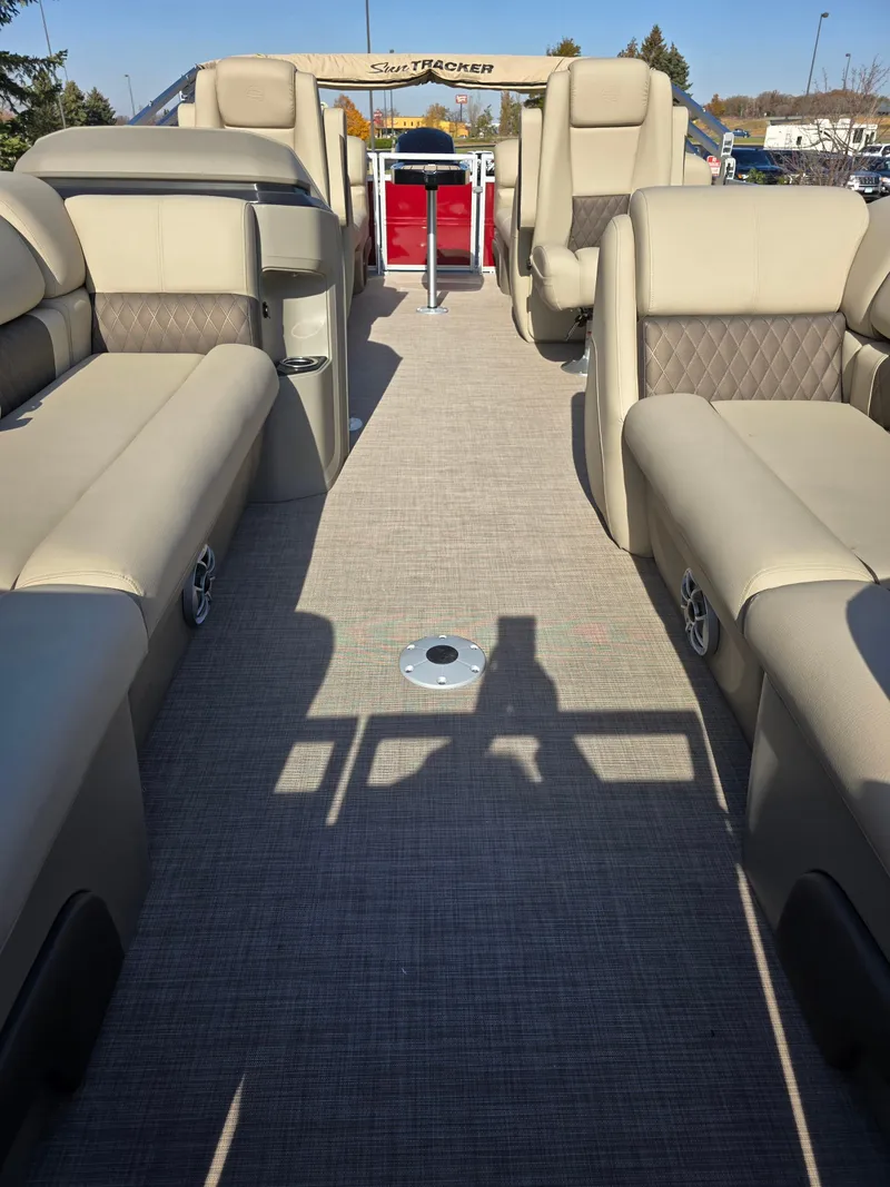 Slide: The Image of 2025 Sun Tracker Party Barge 22 DLX interior with beige seating and spacious layout. - 4