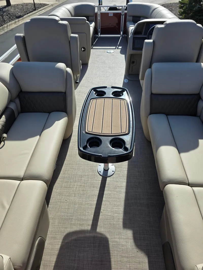 Slide: The Image of 2025 Sun Tracker Party Barge 22 DLX interior with plush seating and central table. - 5