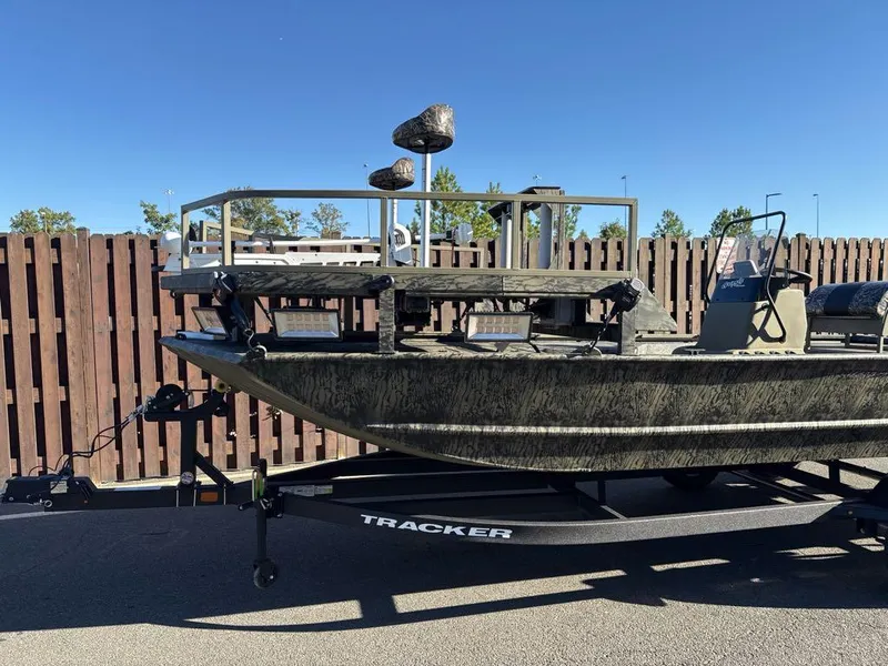 The Image of 2025 Tracker Grizzly 2072 CC Sportsman boat on trailer, parked outdoors. - 0