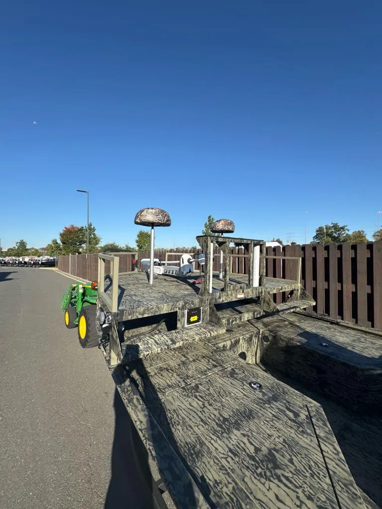 Slide: The Image of 2025 Tracker Grizzly 2072 CC Sportsman boat parked outdoors on a sunny day. - 2