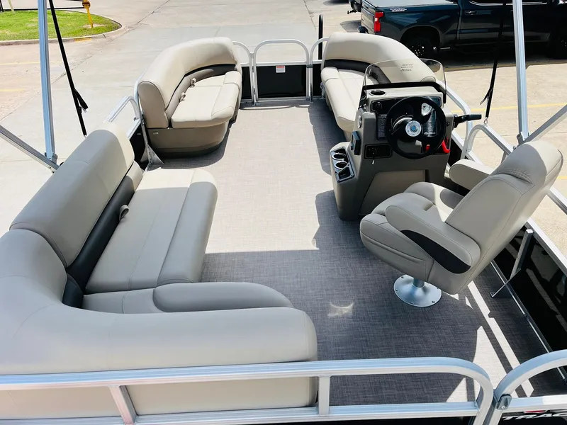 Slide: The Image of 2025 Sun Tracker Party Barge 16 DLX pontoon boat interior with beige seating. - 11
