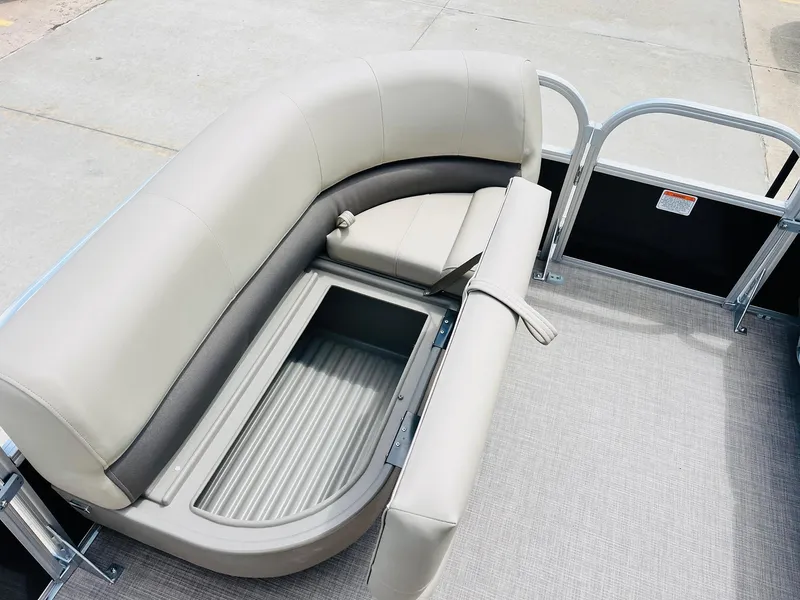 Slide: The Image of 2025 Sun Tracker Party Barge 16 DLX with open storage compartment and cushioned seating. - 14