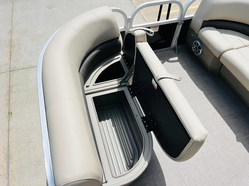 Slide: The Image of 2025 Sun Tracker Party Barge 16 DLX interior with open storage compartment. - 16