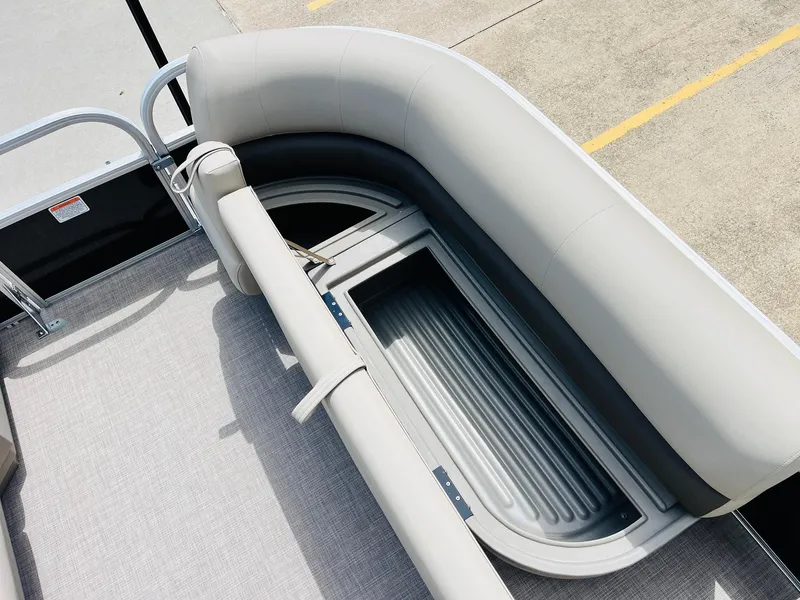 Slide: The Image of 2025 Sun Tracker Party Barge 16 DLX interior seating with storage compartment. - 20