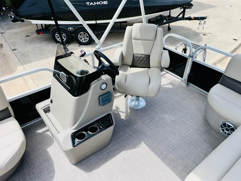 Slide: The Image of 2025 Sun Tracker Party Barge 16 DLX interior with helm and seating. - 22