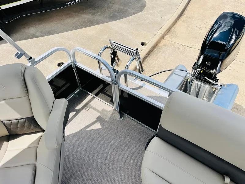 Slide: The Image of 2025 Sun Tracker Party Barge 16 DLX interior with seating and motor view. - 31