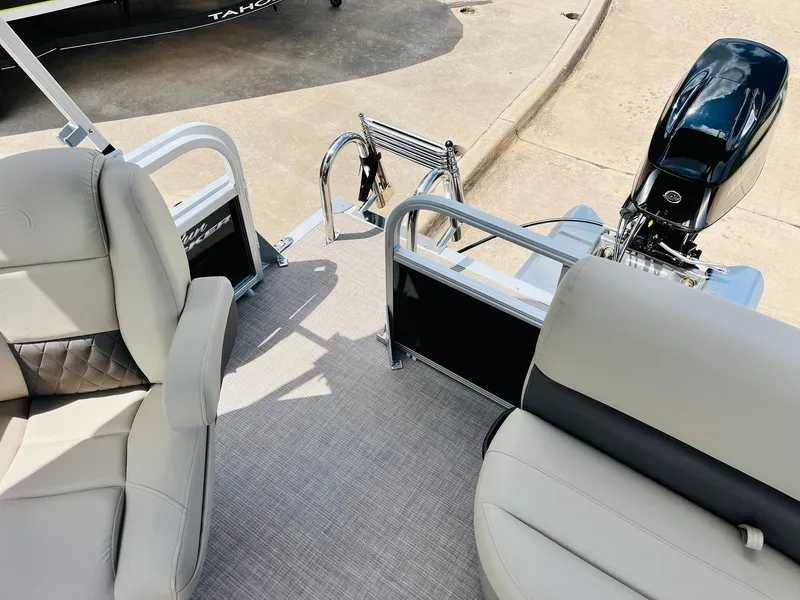 Slide: The Image of 2025 Sun Tracker Party Barge 16 DLX interior with seating and motor view. - 32