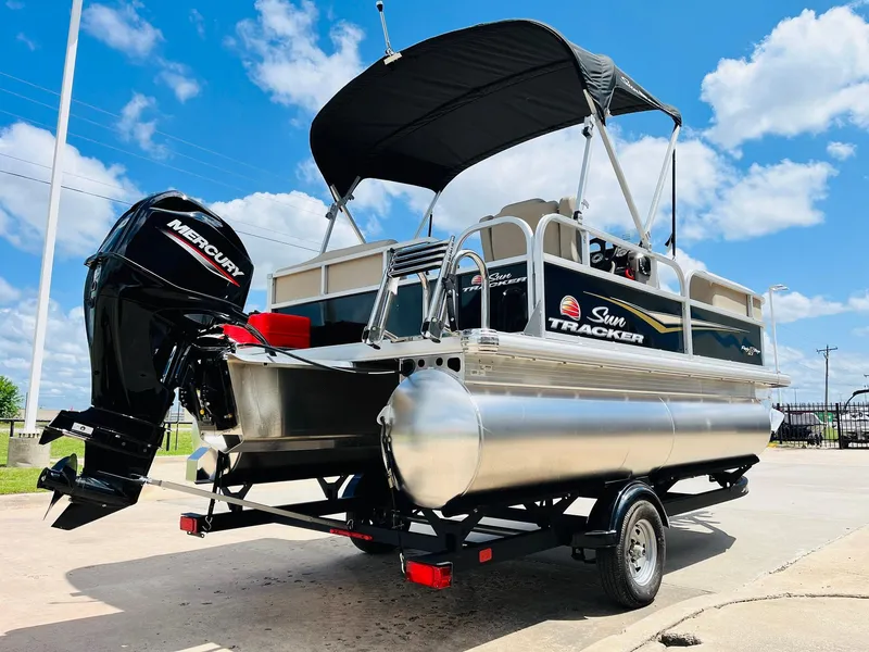 Slide: The Image of 2025 Sun Tracker Party Barge 16 DLX pontoon boat with Mercury engine on trailer. - 6