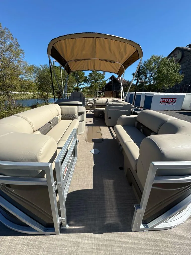 Slide: The Image of 2025 Sun Tracker SportFish 22 XP3 pontoon boat with spacious seating and canopy. - 4