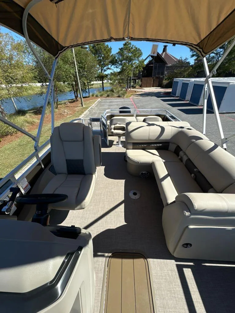 Slide: The Image of 2025 Sun Tracker SportFish 22 XP3 pontoon boat with spacious seating and canopy. - 5