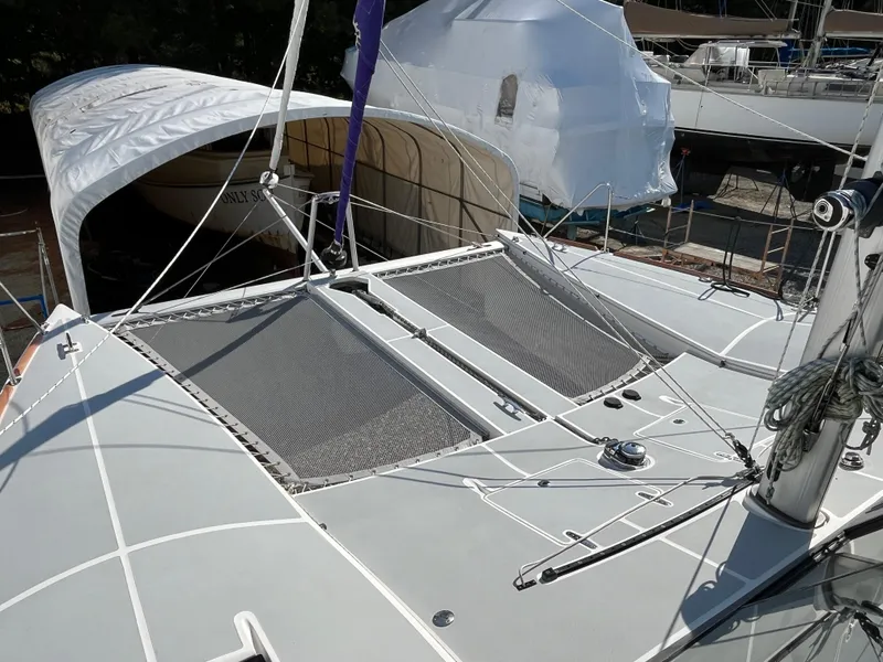 Slide: The Image of 2018 Maine Cat 38 Electric catamaran with netted deck, docked under cover. - 22