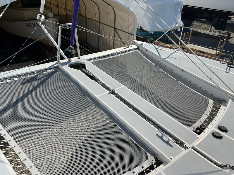 Slide: The Image of 2018 Maine Cat 38 Electric catamaran with netted deck and rigging. - 24