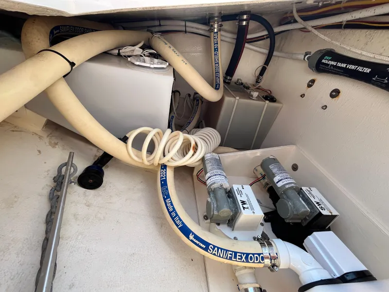 Slide: The Image of Engine compartment of 2018 Maine Cat 38 Electric with hoses and mechanical components. - 30