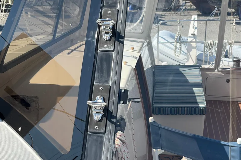 Slide: The Image of Maine Cat 38 Electric 2018 boat interior with seating and secure door latches. - 32