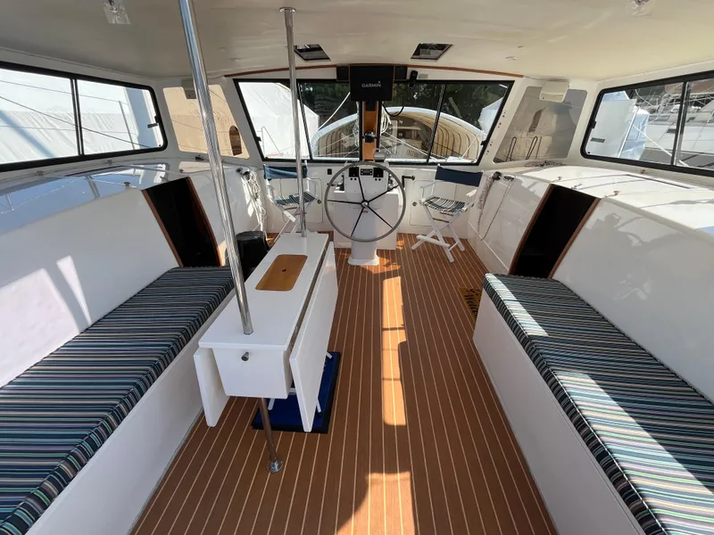Slide: The Image of Interior of 2018 Maine Cat 38 Electric with striped seating and wooden flooring. - 34