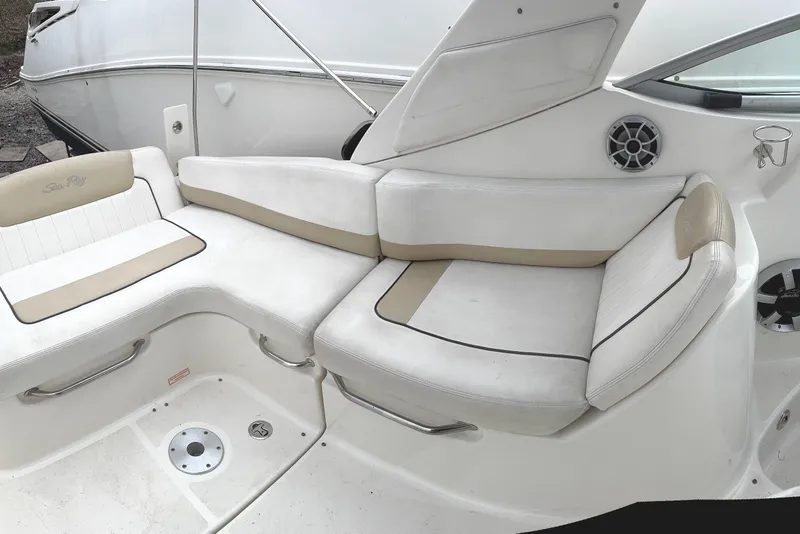 Slide: The Image of 2010 Sea Ray 280 Sundancer boat seating area with white and beige cushions. - 10