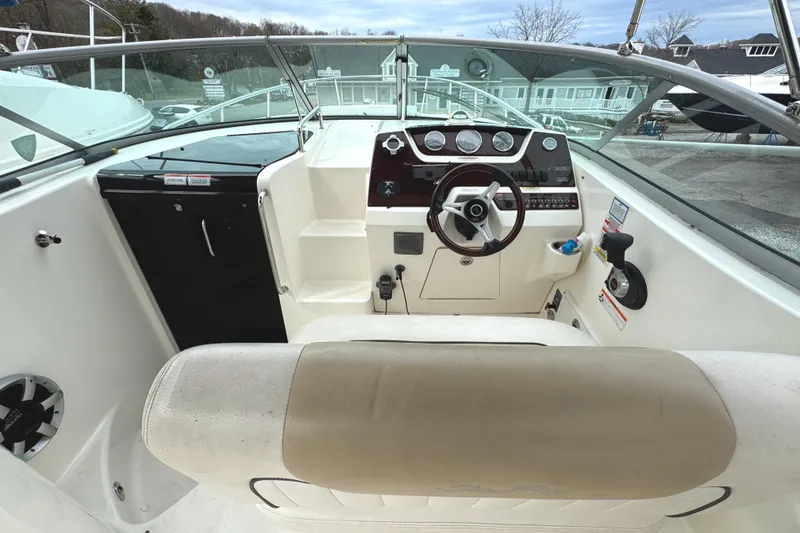 Slide: The Image of 2010 Sea Ray 280 Sundancer cockpit with steering wheel and dashboard controls. - 12