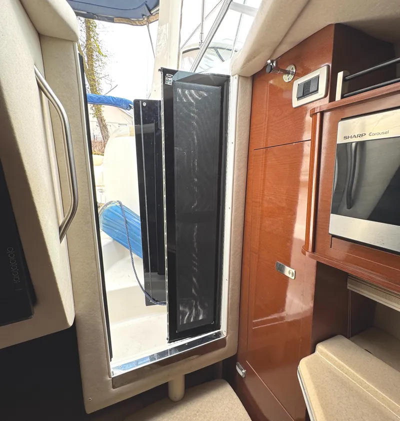Slide: The Image of Interior view of 2010 Sea Ray 280 Sundancer, featuring a door and microwave. - 26