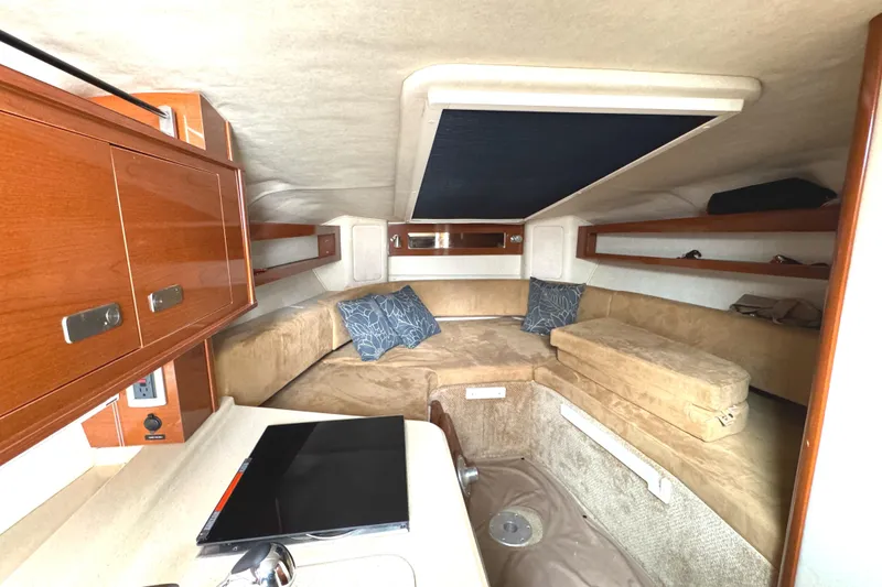 Slide: The Image of Interior of 2010 Sea Ray 280 Sundancer with cozy seating and wooden cabinetry. - 27