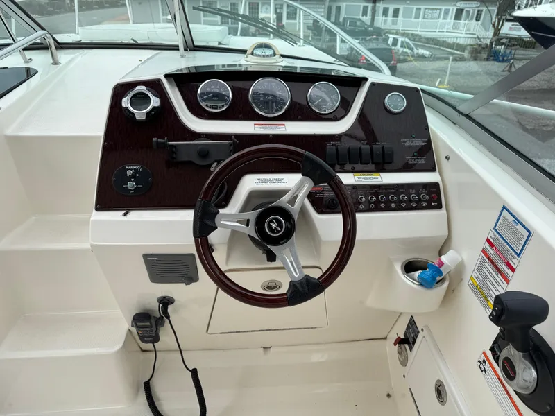 Slide: The Image of Steering console of a 2010 Sea Ray 280 Sundancer boat with gauges and controls. - 4