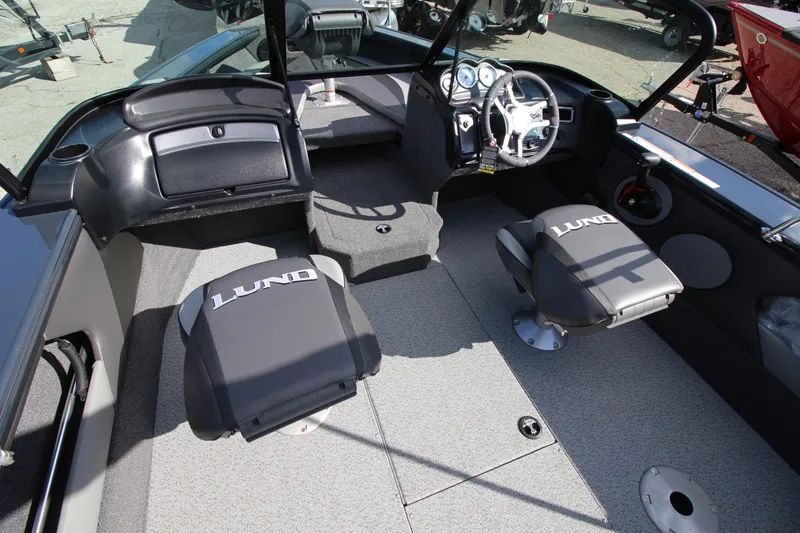 Slide: The Image of 2024 Lund 1775 Crossover XS boat interior with seating and steering console. - 10