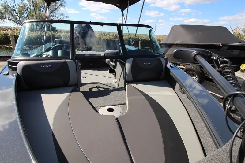 Slide: The Image of 2024 Lund 1775 Crossover XS boat interior with seating and windshield. - 5